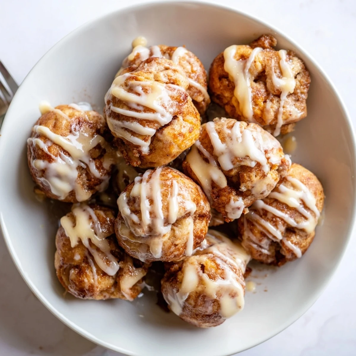 Warm, soft cinnamon roll bites coated in buttery sugar, perfect for brunch gatherings.  