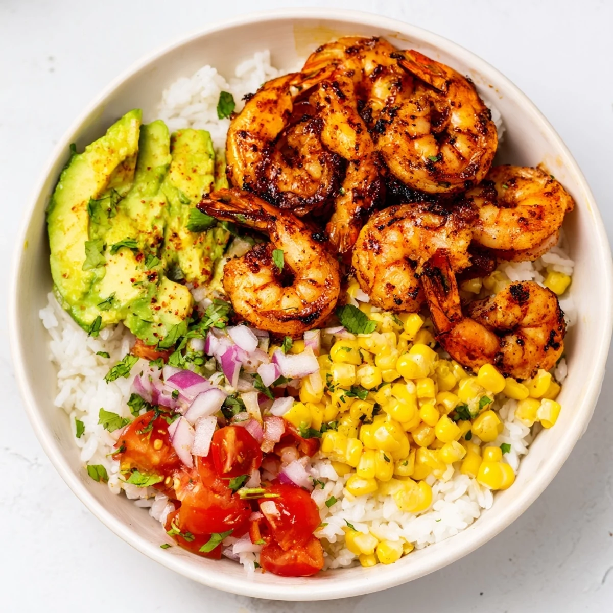 Easy grilled shrimp bowl with colorful avocado salsa, a fresh summer entree.
