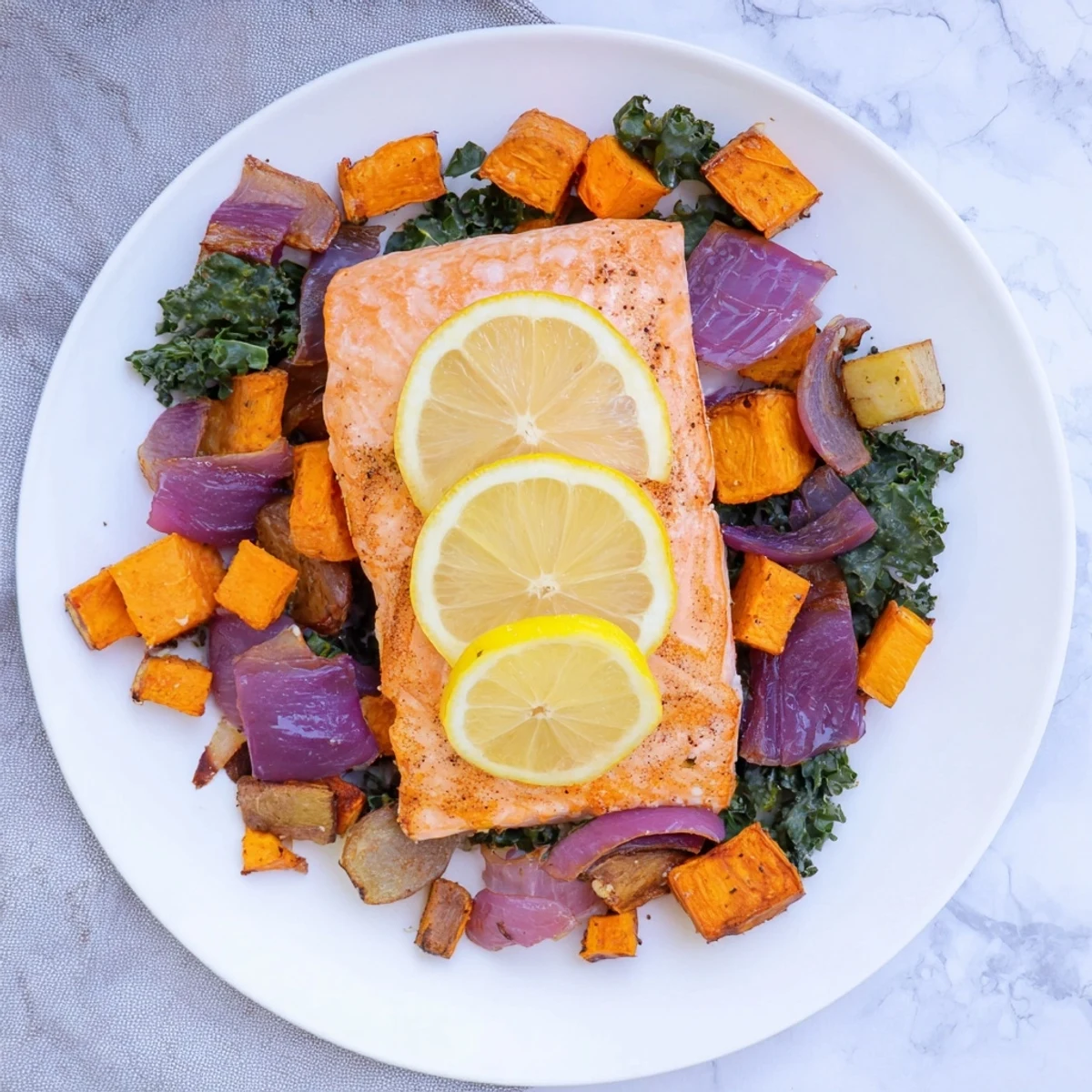 Golden sheet-pan salmon with winter vegetables: tender fish atop roasted, caramelized root veggies.