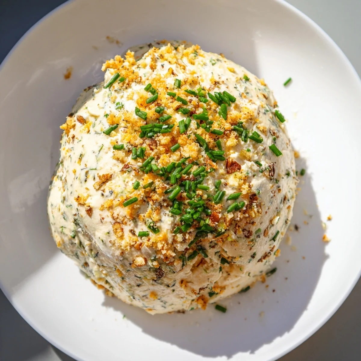A perfectly round Classic Cheese Ball with Ranch Seasoning coated in toasty, crunchy pecans.