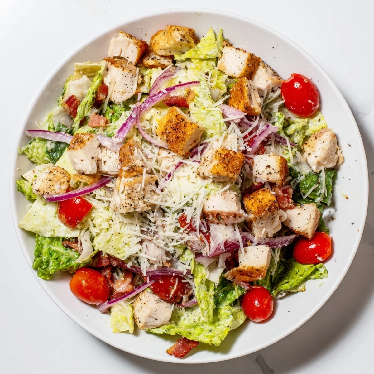 Enjoy the tempting sight of this Costco Chicken Bake Salad Bowl overflowing with fresh vegetables, cheese, and crunchy croutons.