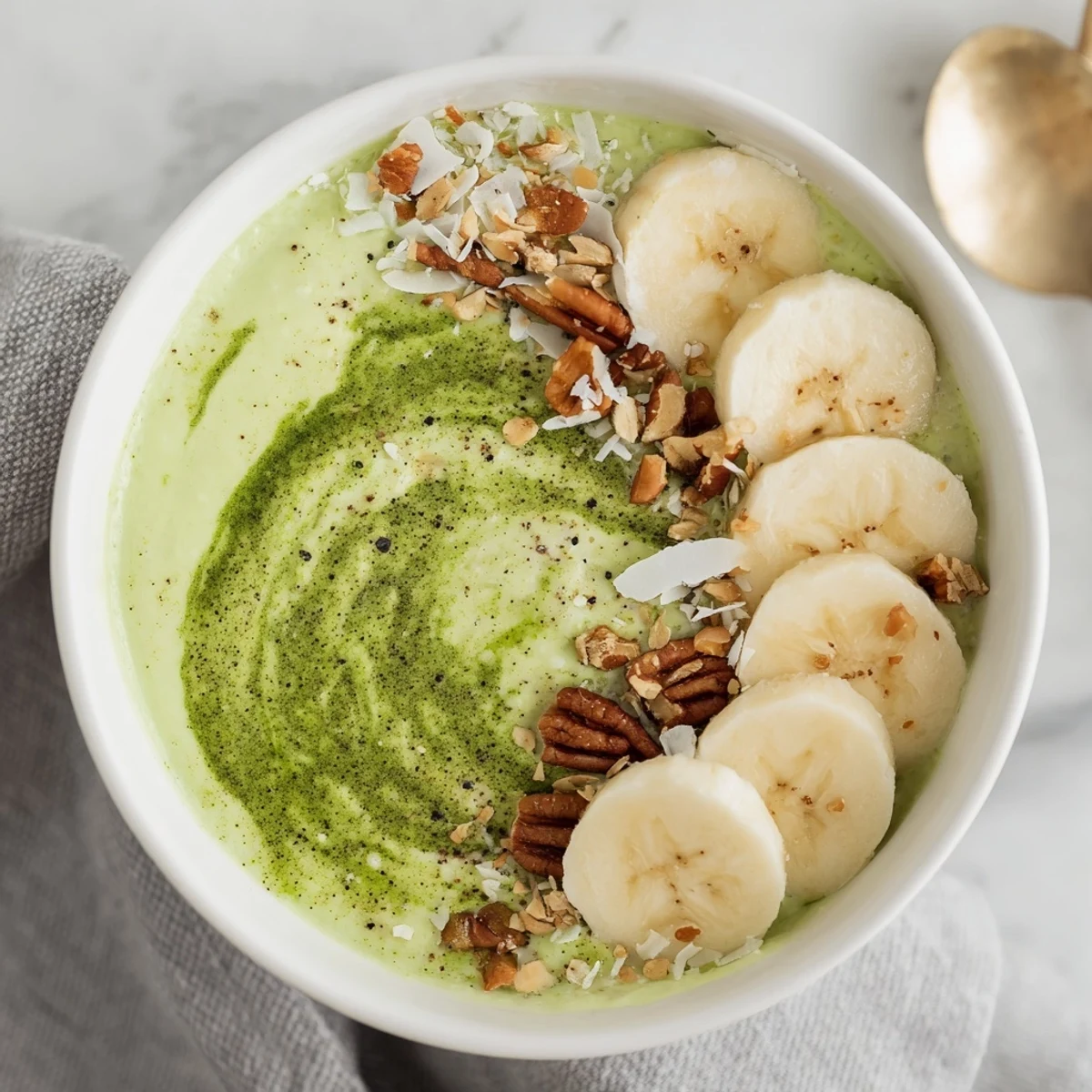 Creamy High-Protein Eggnog Matcha Overnight Oats, chilled and topped with sliced bananas and toasted coconut.