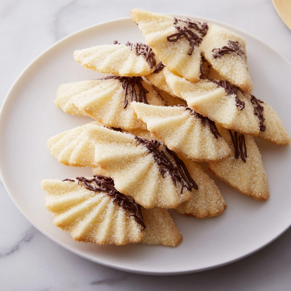 Golden-edged Spritz Cookies arranged in layered fans—a festive treat, perfect for your holiday cookie tray.