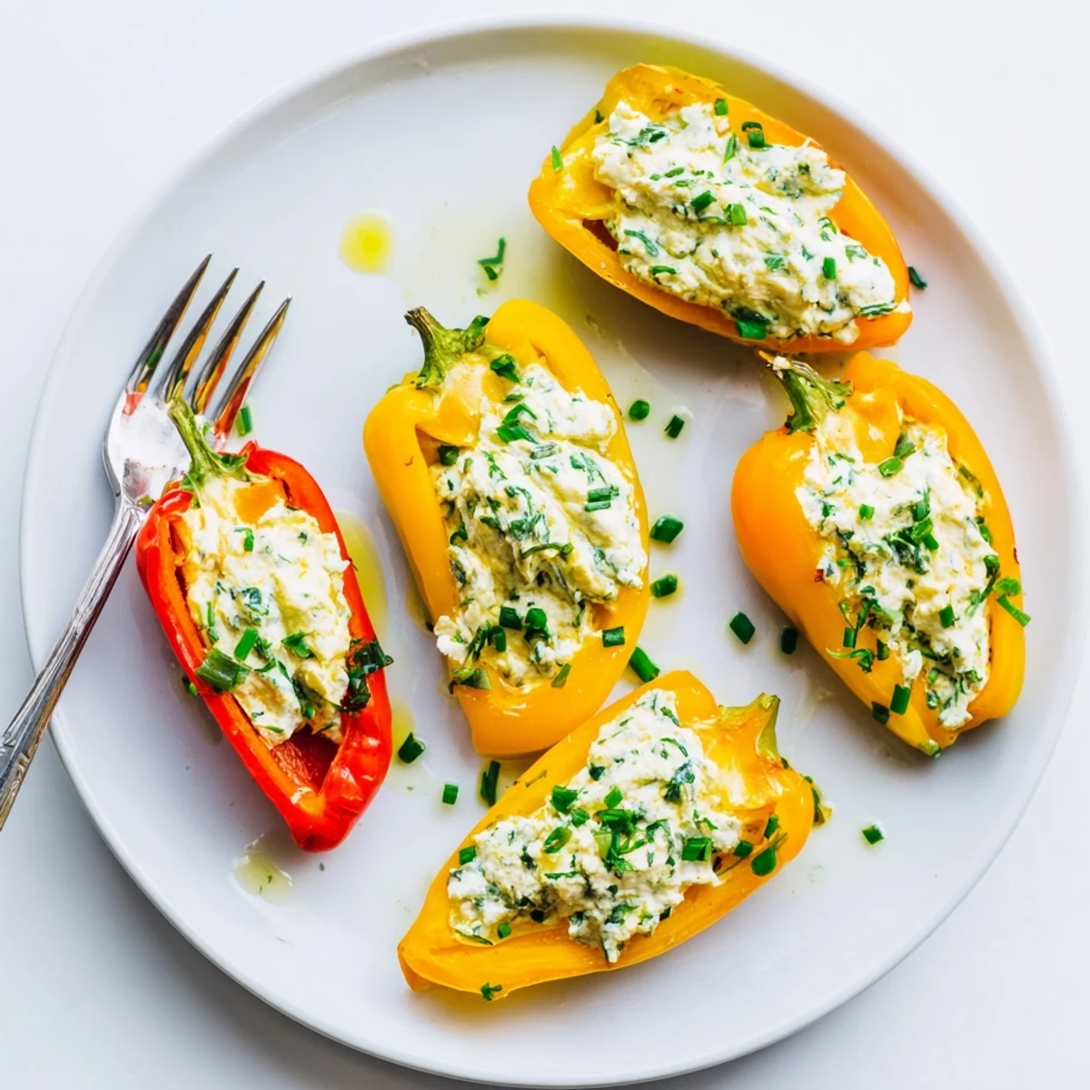 Vibrant mini bell pepper halves overflowing with creamy feta filling, ideal vegetarian appetizer.