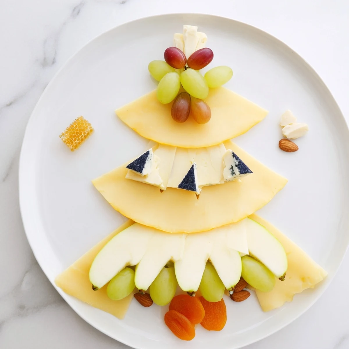 This Art Deco Arch Cheese Platter displays tiers of cheeses artfully arranged with fruit and nuts.