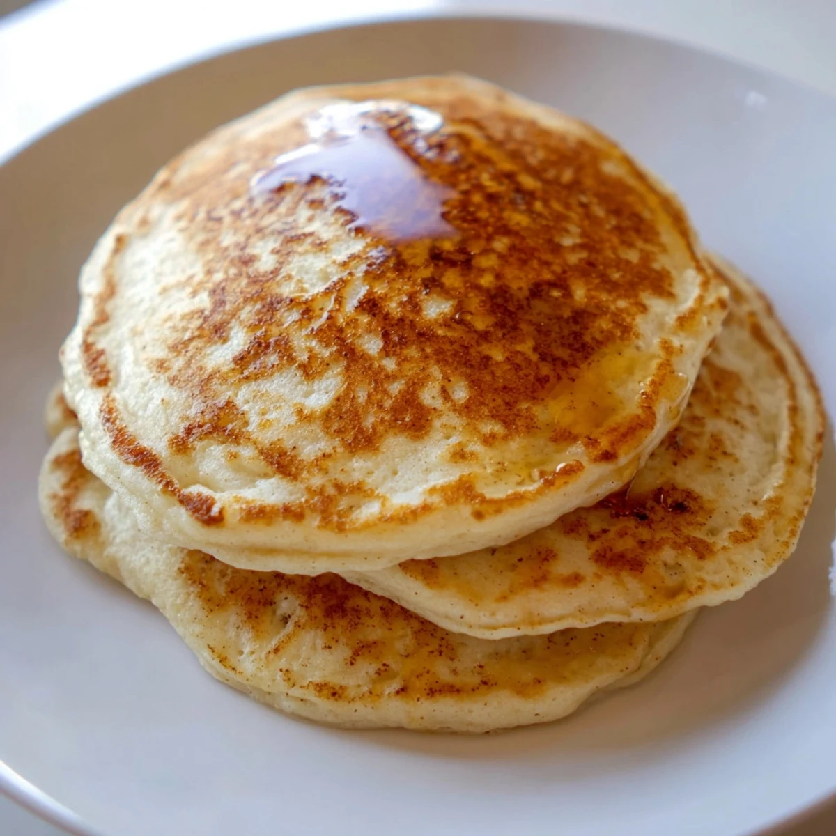A stack of delicious, light and airy Protein Banana Pancakes, perfect for a protein-rich breakfast.