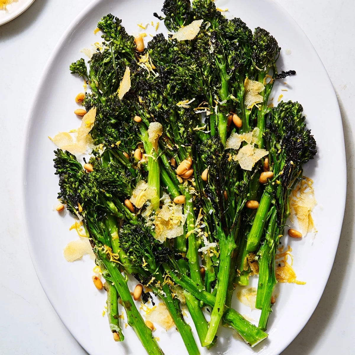 Air-fried charred broccolini salad, topped with crispy garlic and toasted pine nuts; a delicious side.