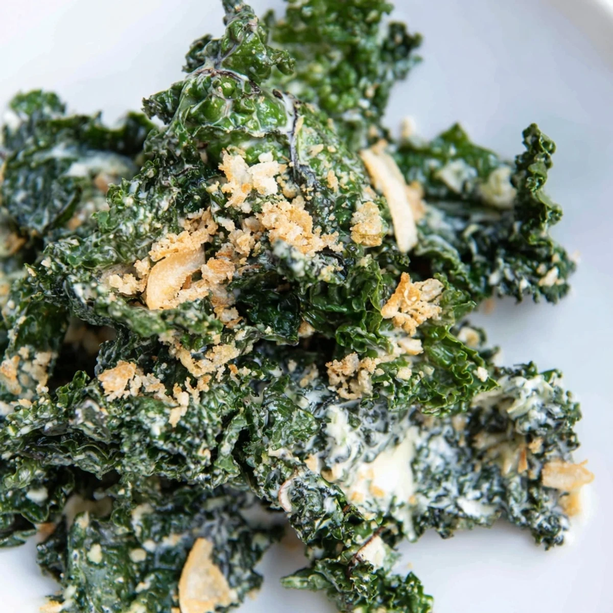 A vibrant bowl of garlic Parmesan kale salad, featuring tender greens, shaved Parmesan, and a light lemony dressing for a healthy lunch.