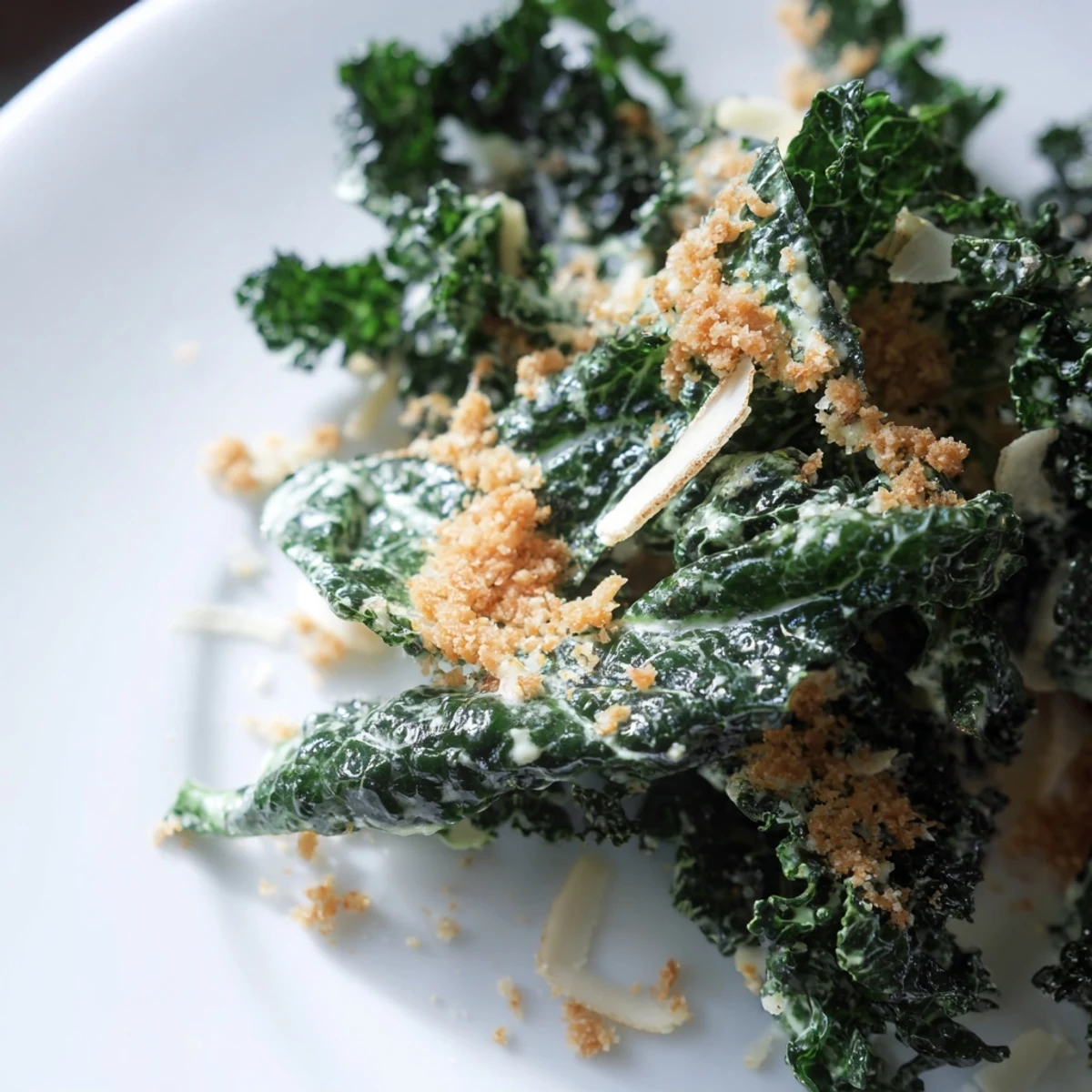 This vegetarian garlic Parmesan kale salad is served with crisp breadcrumbs, ready to enjoy as a flavorful 15-minute dinner side dish.