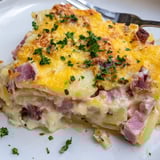 Creamy Cheesy Potato and Ham Casserole, ready to be served with chopped parsley garnish.