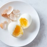 This photo displays perfectly cooked Air Fryer Boiled Eggs, with bright yellow yolks and smooth whites.