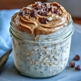 Indulgent yet healthy protein cookie dough overnight oats ready for breakfast enjoyment.