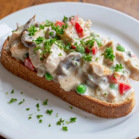Creamy Chicken à la King over toast, a warm and comforting dish with golden, toasted bread beneath.