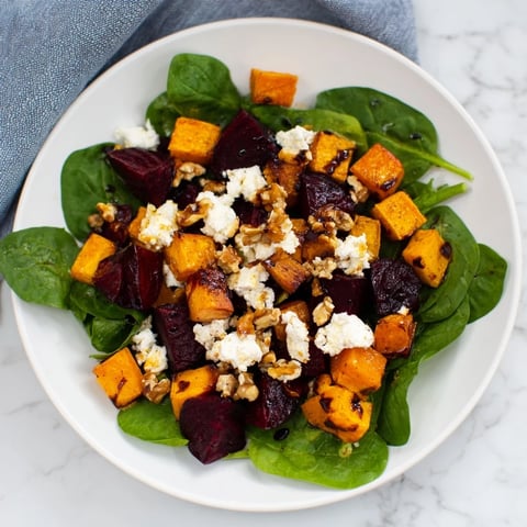 Roasted Beet, Butternut & Spinach Salad, a colorful vegetarian delight with crumbled goat cheese.