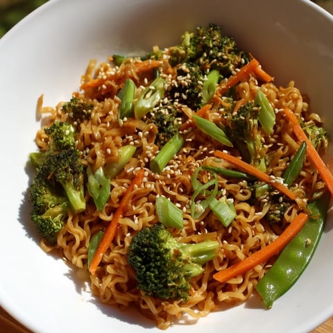 Steaming bowl of Ramen Noodle Stir-Fry Remix: a flavorful weeknight meal with colorful vegetables and sauce.