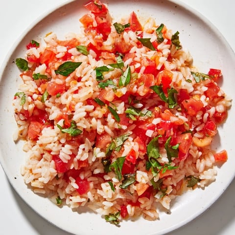 Steaming Tomato-Rice Skillet Dinner, with fluffy rice and vibrant tomatoes, ready to serve with fresh parsley.