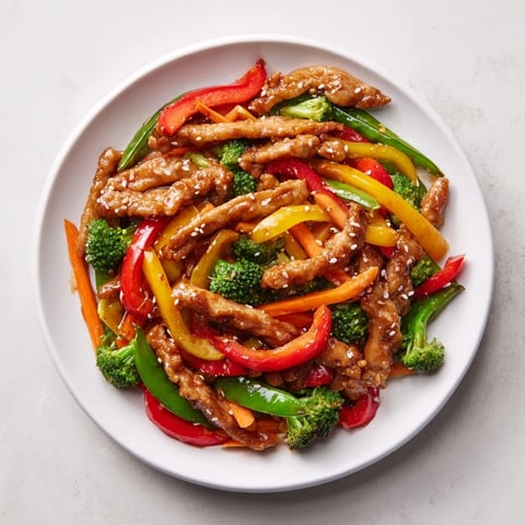 Chicken Stir-Fry with colorful vegetables and fluffy rice, glistening beautifully from the savory sauce.
