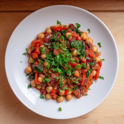 Golden, steaming Vegetarian Chickpea & Spinach Skillet, garnished with fresh herbs, ready to serve alongside crusty bread.