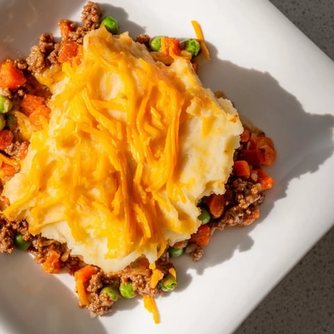 Budget Shepherds Pie with a golden, cheesy mashed potato crust, perfect comfort food.