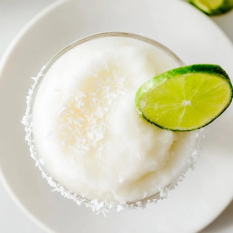 A frosty, vibrant White Christmas Margarita Slush, a creamy cocktail perfect for holiday sipping.