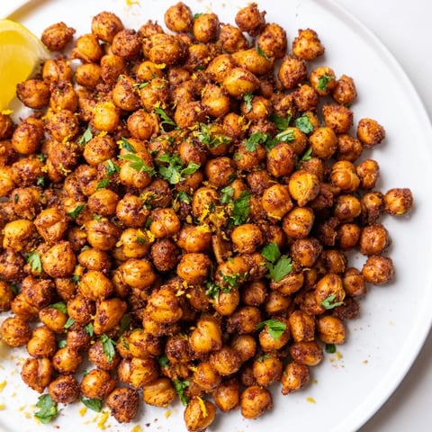 Golden, crispy Harissa Chickpea Roast, fragrantly spiced and ready, served on a baking sheet.