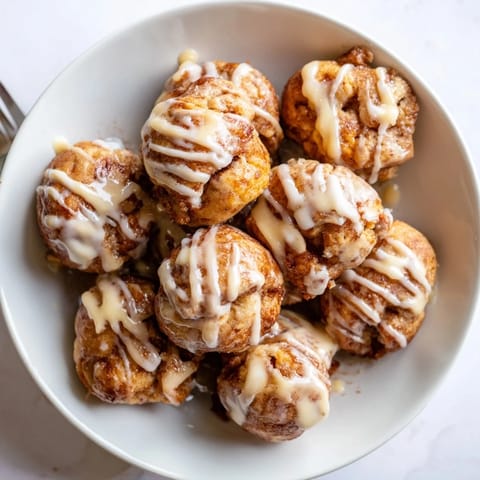 Warm, soft cinnamon roll bites coated in buttery sugar, perfect for brunch gatherings.  