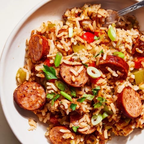 Hearty One-Pot Cajun Sausage and Rice, garnished with fresh parsley and green onions.  