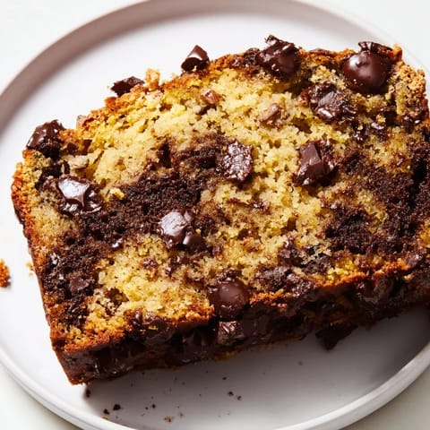 Freshly baked chocolate chip banana bread, golden brown and fragrant, ready to enjoy.  