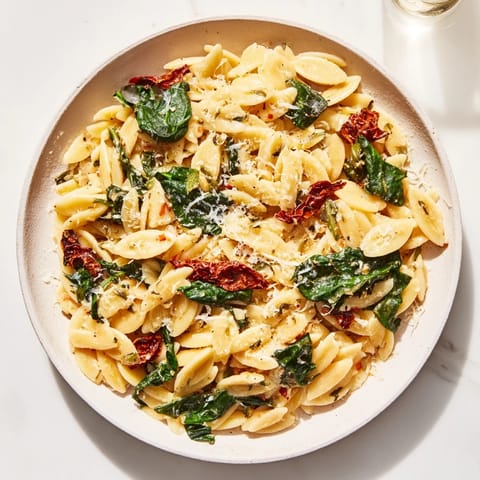 A close-up of a creamy Tuscan Orzo Bowl, showing the delightful texture and ingredients.