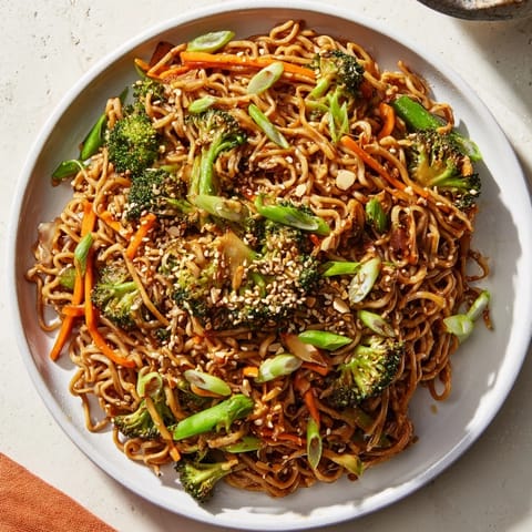 Sizzling Ramen Noodle Stir-Fry Remix: a close-up shows tender noodles and crisp vegetables, ready to serve and enjoy.