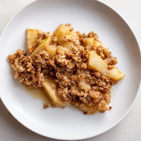 Warm and bubbly Best Apple Crisp, showcasing soft cinnamon-spiced apples beneath a crunchy topping.