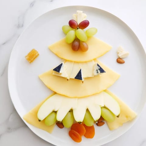 This Art Deco Arch Cheese Platter displays tiers of cheeses artfully arranged with fruit and nuts.