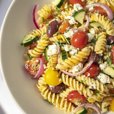 Cooling view of a delicious Lemon Pasta Salad, tossed with colorful vegetables, ready to serve.