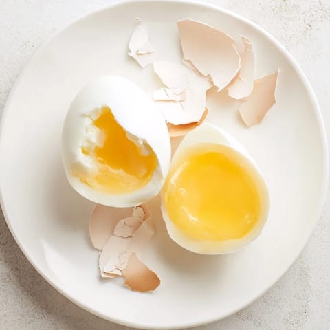 Shiny, golden Air Fryer Boiled Eggs, ready to peel and enjoy as a quick, protein-packed breakfast.