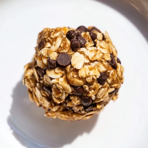 Ripe banana and chocolate chips mixed into wholesome oat energy balls, ideal for on-the-go breakfasts or afternoon treats.