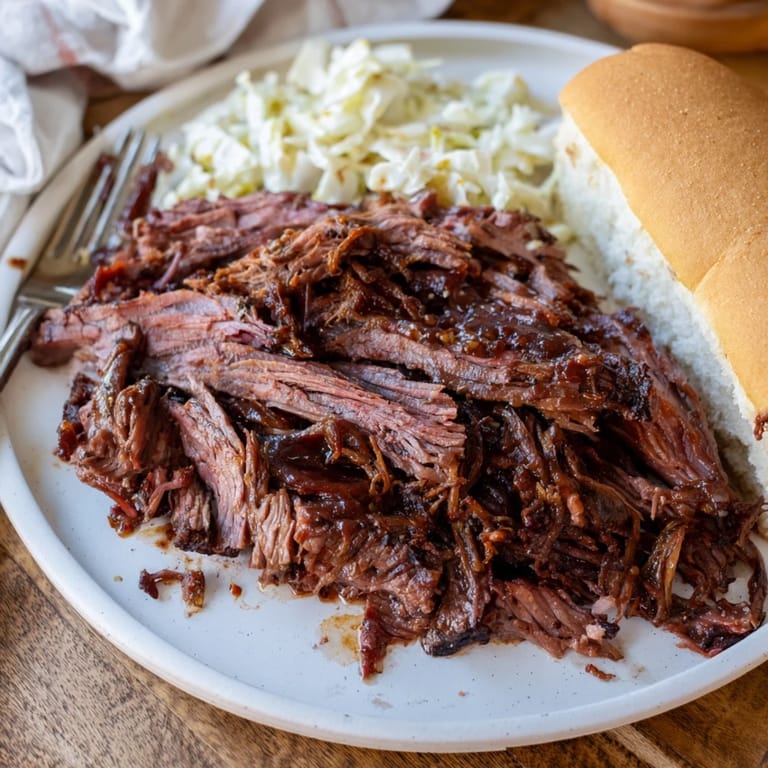 Rich and flavorful pulled pork slow-cooked in barbecue sauce, perfect for hearty sandwiches.  