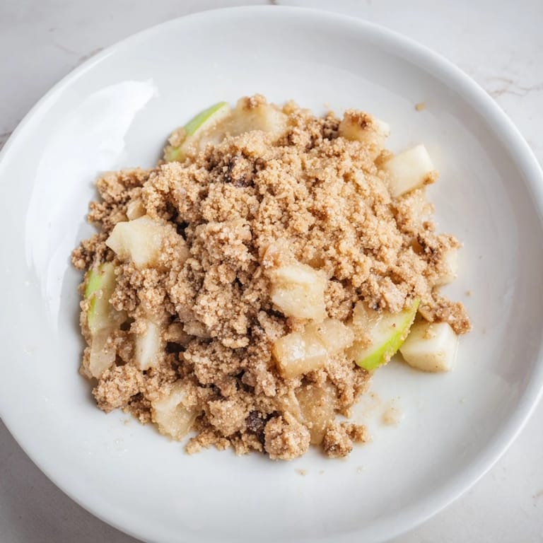 A classic Best Apple Crisp, ready to serve warm with melting vanilla ice cream and whipped cream.