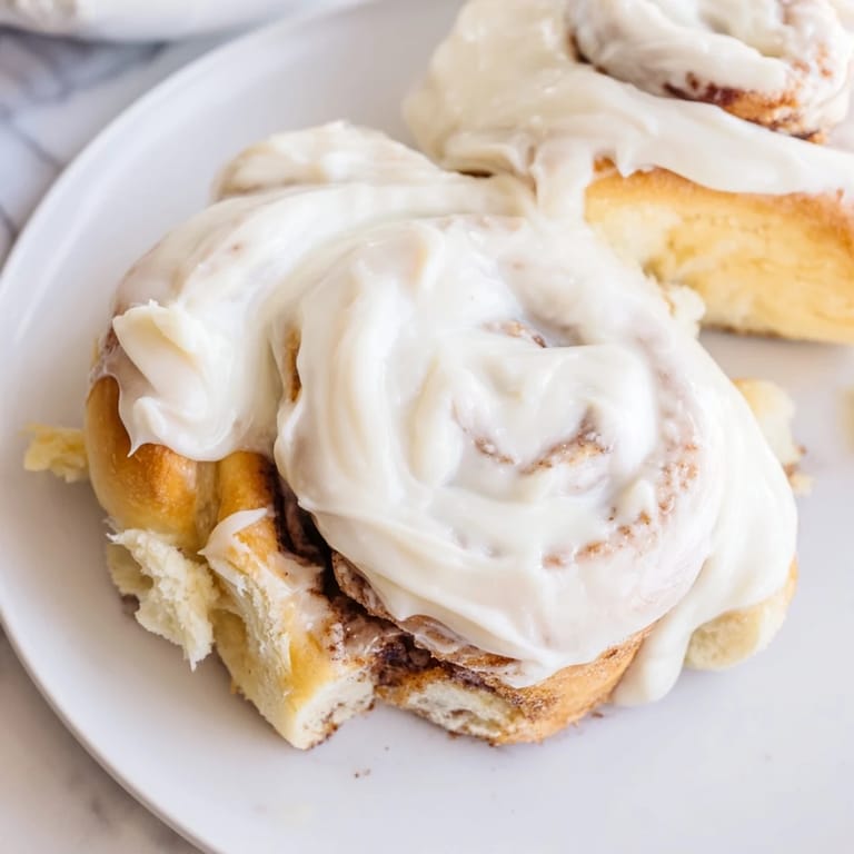 Close-up of freshly baked Viral TikTok Heavy Cream Cinnamon Rolls, revealing soft, layered dough and rich filling.