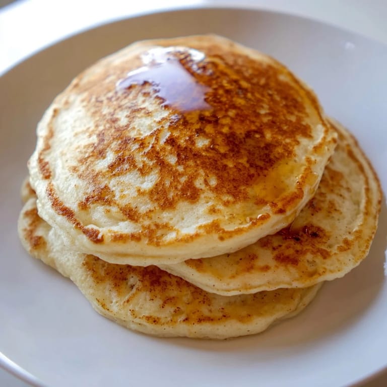 A stack of delicious, light and airy Protein Banana Pancakes, perfect for a protein-rich breakfast.