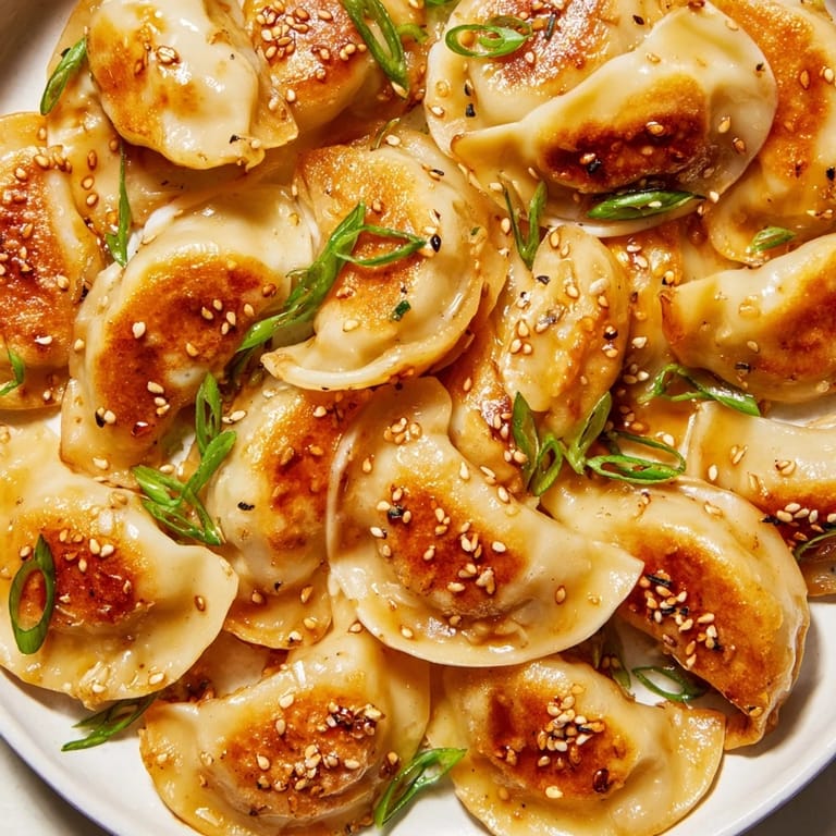 Visualize perfectly cooked, savory air fryer frozen dumplings with a flavorful sesame oil drizzle.