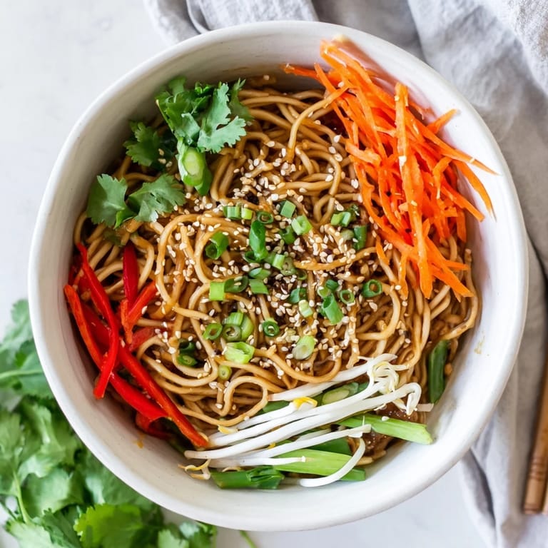 Hearty Asian Garlic Noodle Bowl served in a bowl with julienned carrots and crisp bean sprouts for added texture.