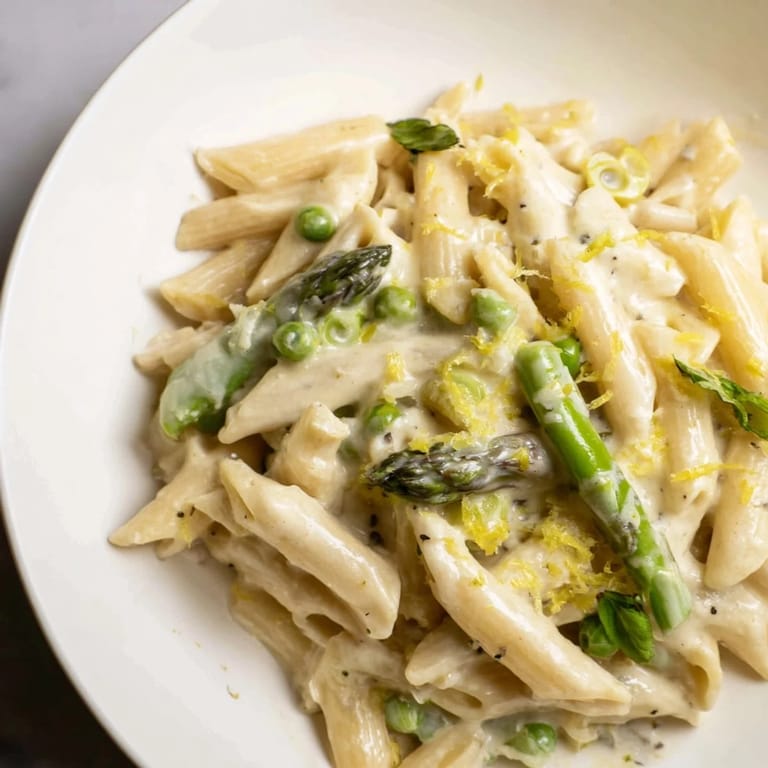 Vibrant Garlic Parmesan Spring Vegetable Pasta with al dente penne, crisp-tender veggies, and a silky sauce, ready to serve.