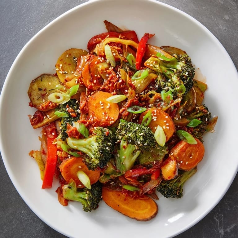 Colorful Comforting Fermented Veggie Winter Stir-Fry in a skillet, finished with crunchy kimchi, green onions, and sesame seeds.  