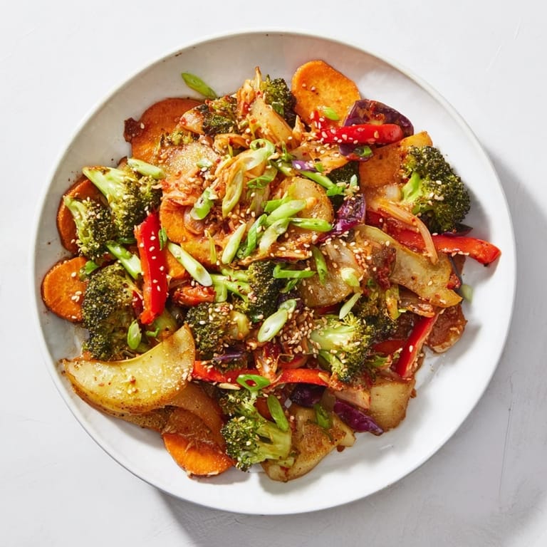 Overhead view of the vegetarian Comforting Fermented Veggie Winter Stir-Fry, showcasing vibrant cabbage and bell peppers on a rustic wooden board.
