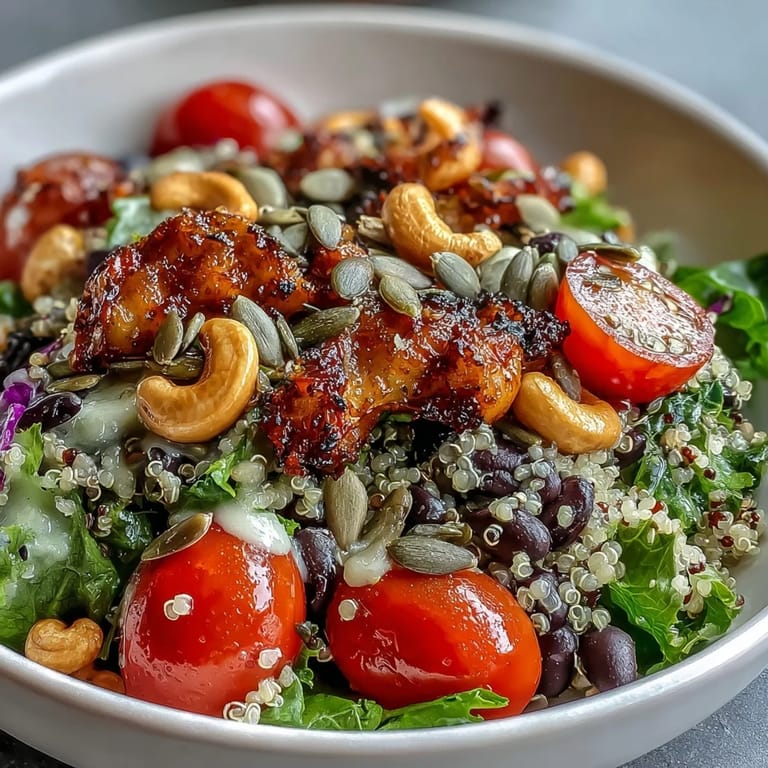 Serving suggestion for a Rainbow Salad Bowl topped with pumpkin seeds, fresh parsley, and a lemon wedge.